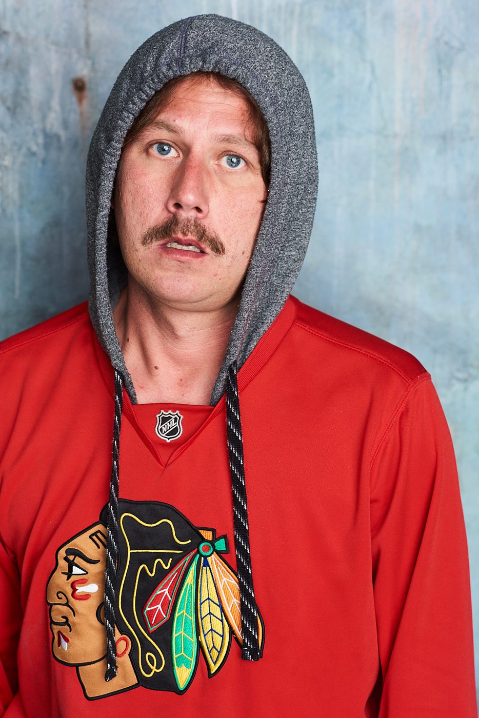Joe Uhlarik in a Blackhawks hoodie, waiting