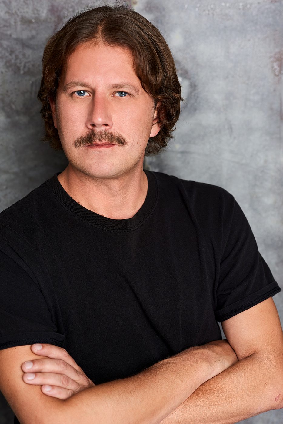 Joe Uhlarik headshot, serious, black t-shirt